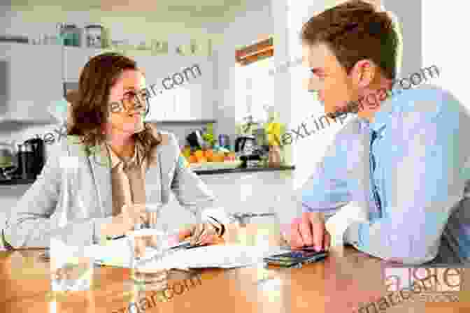 A Couple Sitting At A Table Discussing Divorce. Personal Bankruptcy Through The Looking Glass