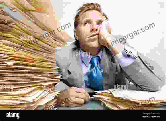 A Person Sitting At A Desk Looking At A Pile Of Bills. Personal Bankruptcy Through The Looking Glass